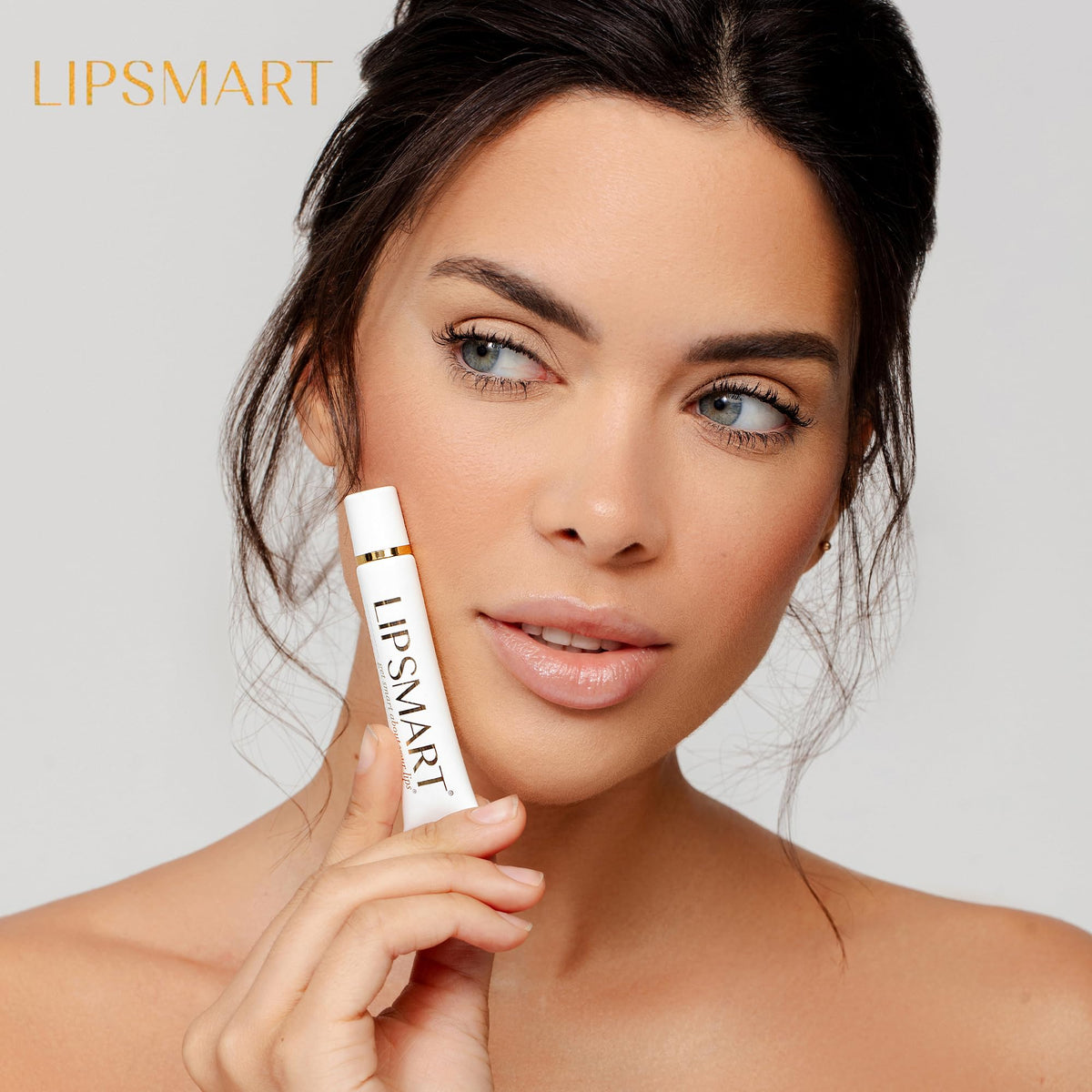 LipSmart next to a hand for size and travel-friendly convenience