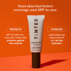Live Tinted applying Hueguard with fingers blended on cheek for even coverage