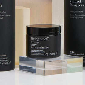 Living Proof product in use styling hair to add lift and touchable texture