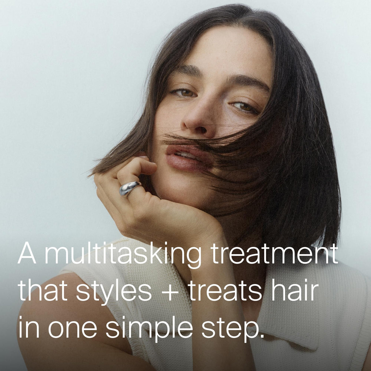 Living Proof apply to hair action demonstrating even application and styling control
