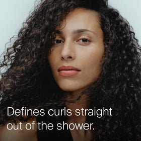 Living Proof label close-up highlighting product name and curl-defining benefit
