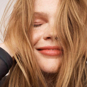 Living Proof dry shampoo being sprayed during morning routine, fast refresh without water