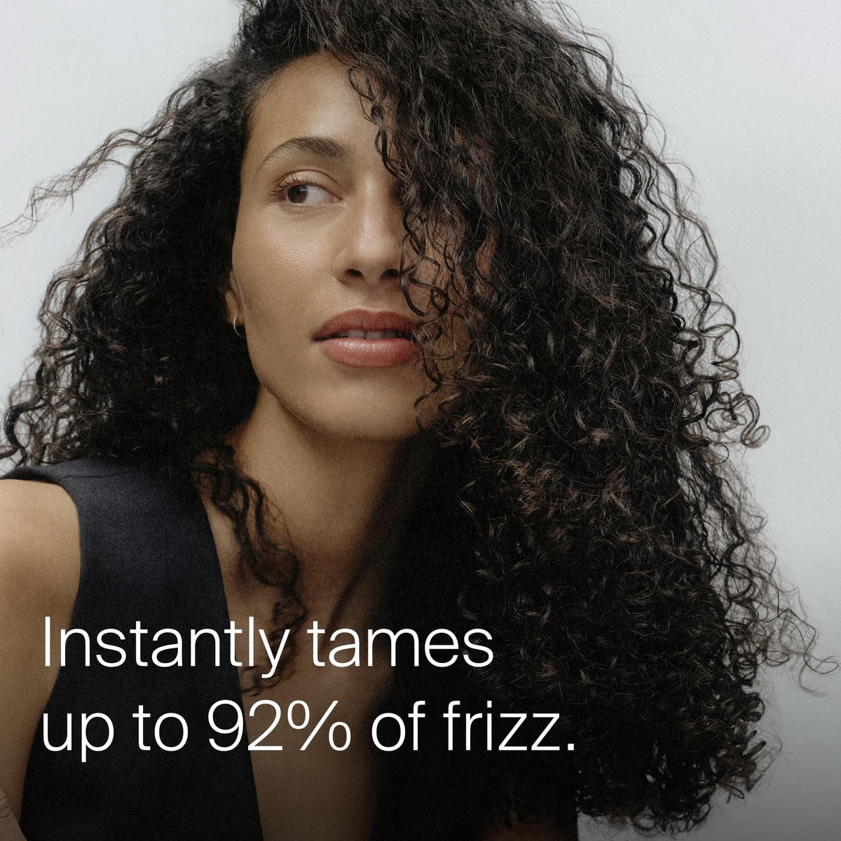 Living Proof being applied to dry hair for quick frizz control benefit