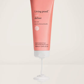 living proof styled curls in natural light showing defined, frizz-reduced benefit