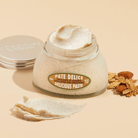 L'Occitane paste texture close-up revealing almond shell grains and creamy butter for exfoliation