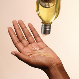 Close-up of L'OCCITANE bottle label highlighting product name and recyclable material