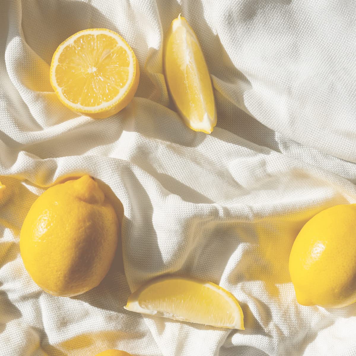 Verbena, lemon and grapefruit ingredients beside L'Occitane pouch