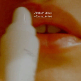L'OCCITANE lip balm inside a purse lifestyle shot showing on-the-go nourishment