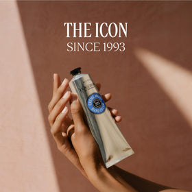 L'OCCITANE on vanity styled with towel and flowers showing everyday luxury use