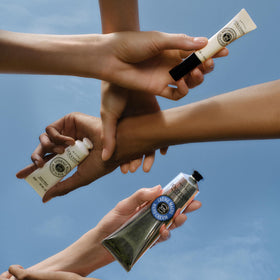 L'Occitane tube next to keys and phone showing travel-friendly benefit