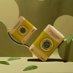 L'OCCITANE shea verbena bar held in hand for scale, showing compact travel-friendly size