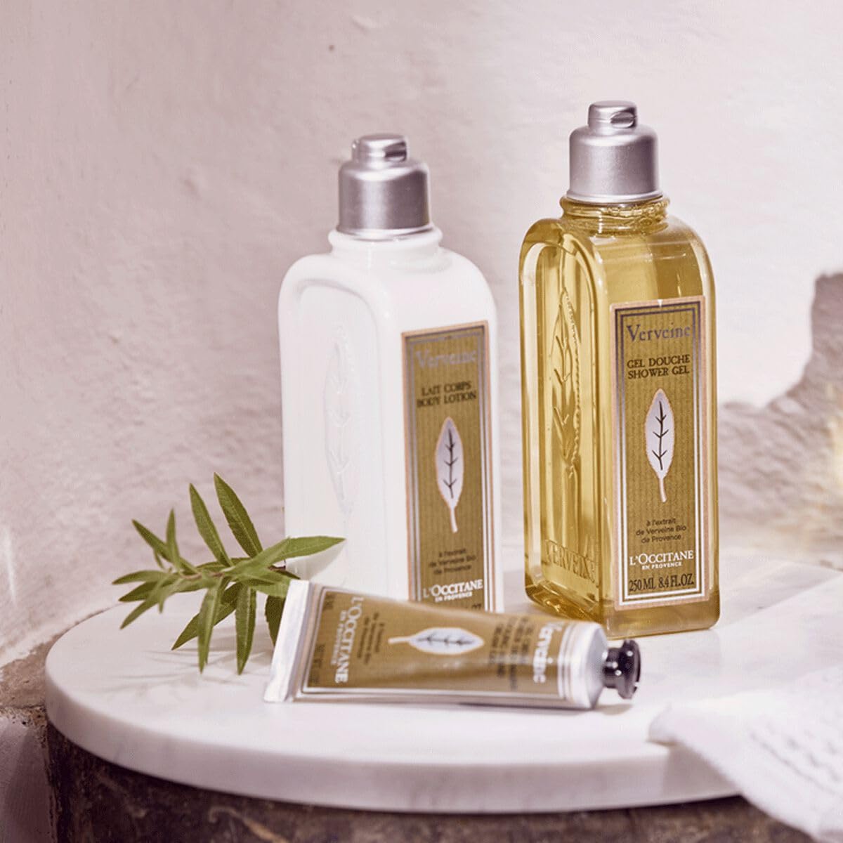 L'Occitane tube beside phone showing pocket-friendly travel convenience benefit