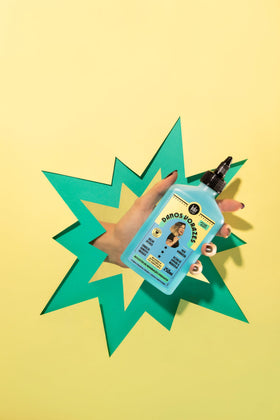 Applying Lola booster to damp hair demonstrating improved manageability