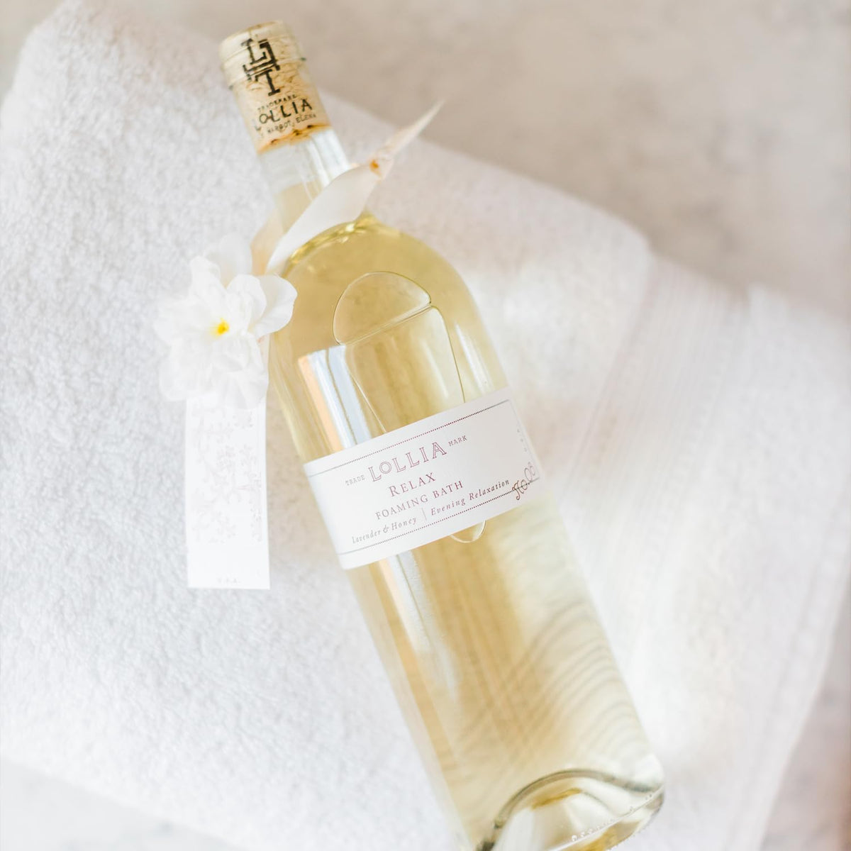 LOLLIA glass bottle detail with cork and sash showcasing premium presentation benefit