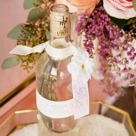 LOLLIA packaging corsage and sash emphasizing decorative gift-ready benefit
