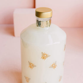 LOLLIA pouring bubble bath into warm water to create gentle, hydrating bubbles