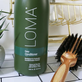 Loma deep conditioner next to common bottle for scale highlighting 33.8 oz value