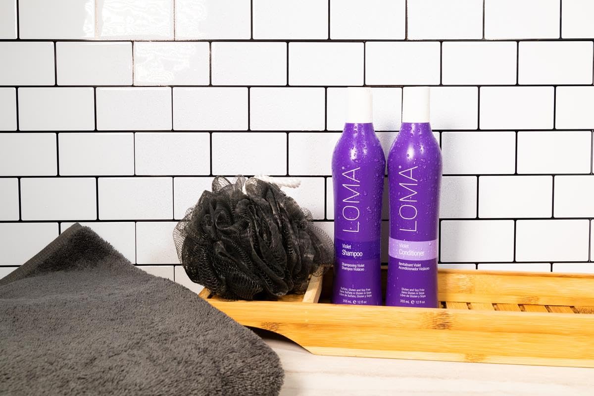 Loma shampoo in hand beside hair for scale and easy dosing benefit