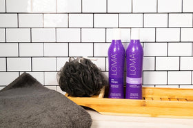 Loma shampoo in hand beside hair for scale and easy dosing benefit