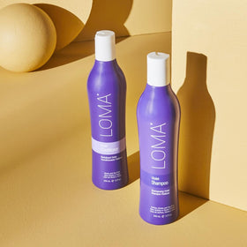 Close-up of Loma shampoo texture demonstrating creamy violet pigment for toning