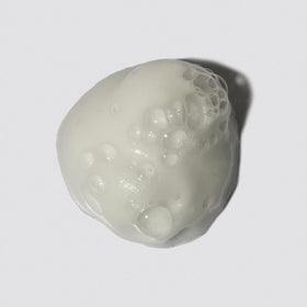 LOMA foam texture in hand showing airy mousse for lightweight volume and touchable hold