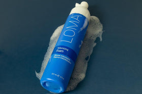 LOMA foam applied while blow-drying hair illustrating heat protection and added lift benefit