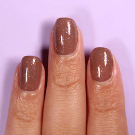 LONDONTOWN top coat on manicured hands adding iridescent depth and long-lasting shine