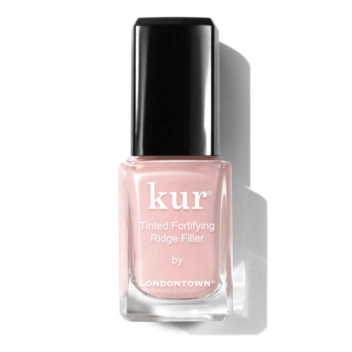 LONDONTOWN Kur bottle front showing petal pink tint and sleek packaging benefit: clear product ID