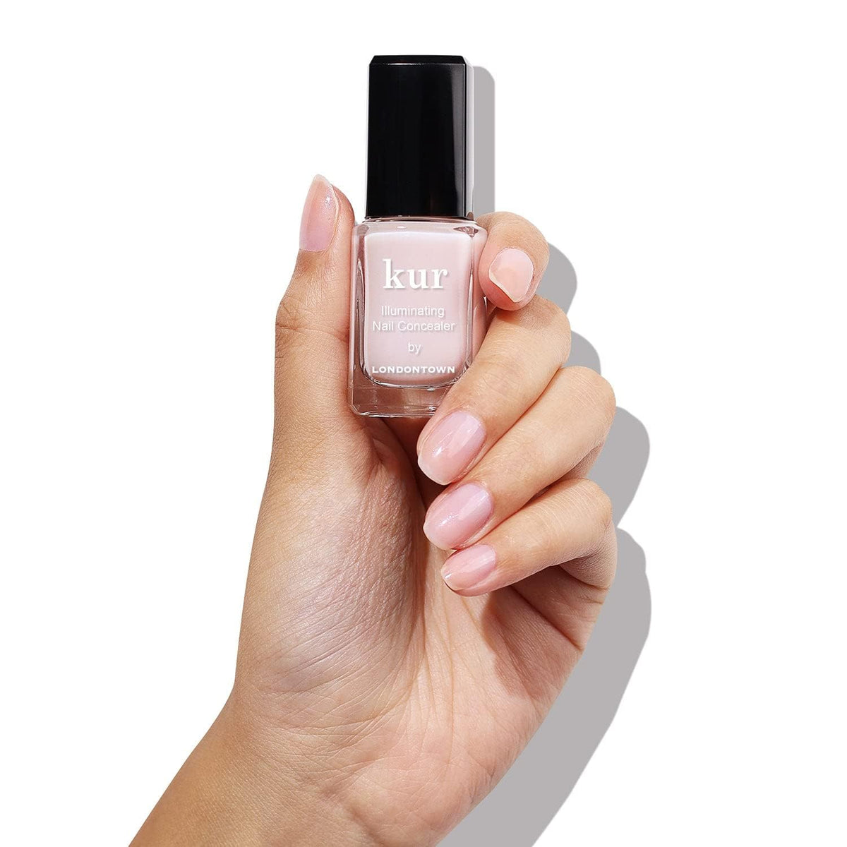 LONDONTOWN kur pink concealer bottle close-up highlighting applicator