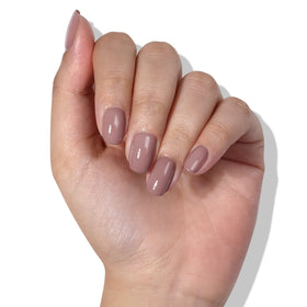 LONDONTOWN polish held in hand to show 0.4 fl oz size and scale