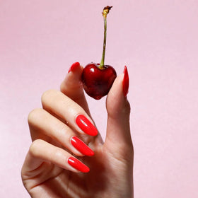 LONDONTOWN manicured hand wearing Lakur red showing durable everyday wear