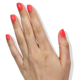 LONDONTOWN Lakur Papaya bottle beside manicured fingers for size and true-color reference