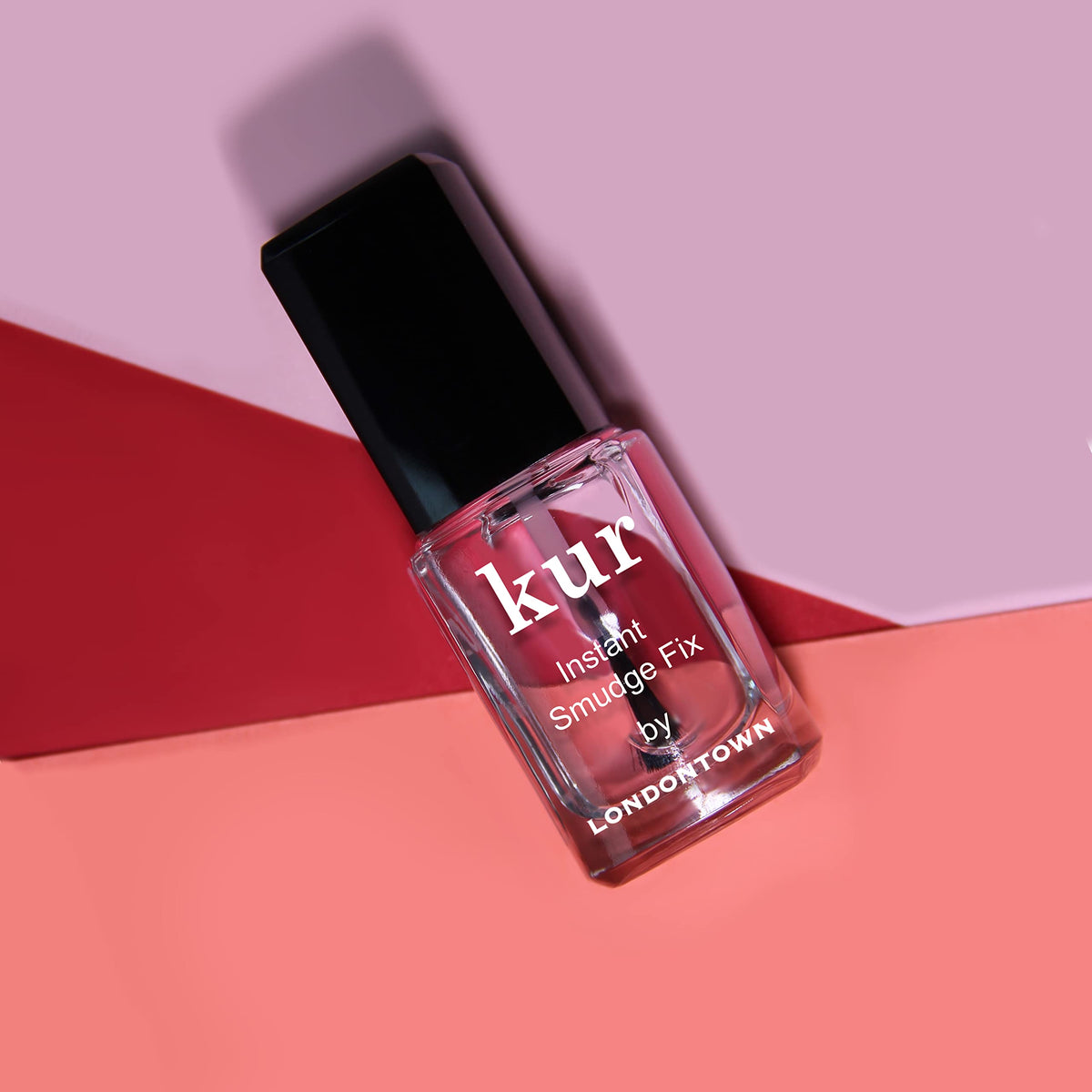 LONDONTOWN in a purse next to manicure tools, ideal for on-the-go touchups
