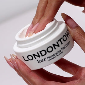 LONDONTOWN treatment gloves displayed with cream to show targeted repair option