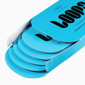 LOOPS single patch close-up on fingers demonstrating gel clarity and cooling benefit