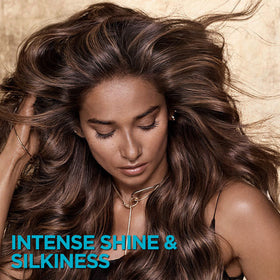 L'Oreal Paris Elvive conditioner in hand showing easy application and slip for detangling