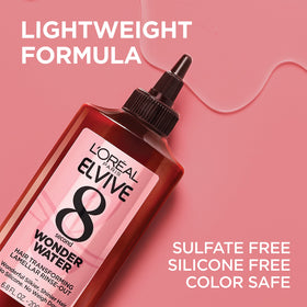 L'Oreal Paris applying wonder water to wet hair for fast smoothing benefit