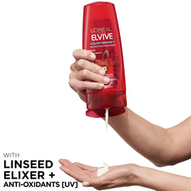L'Oreal Paris Elvive shampoo in shower being lathered, demonstrates gentle cleansing benefit