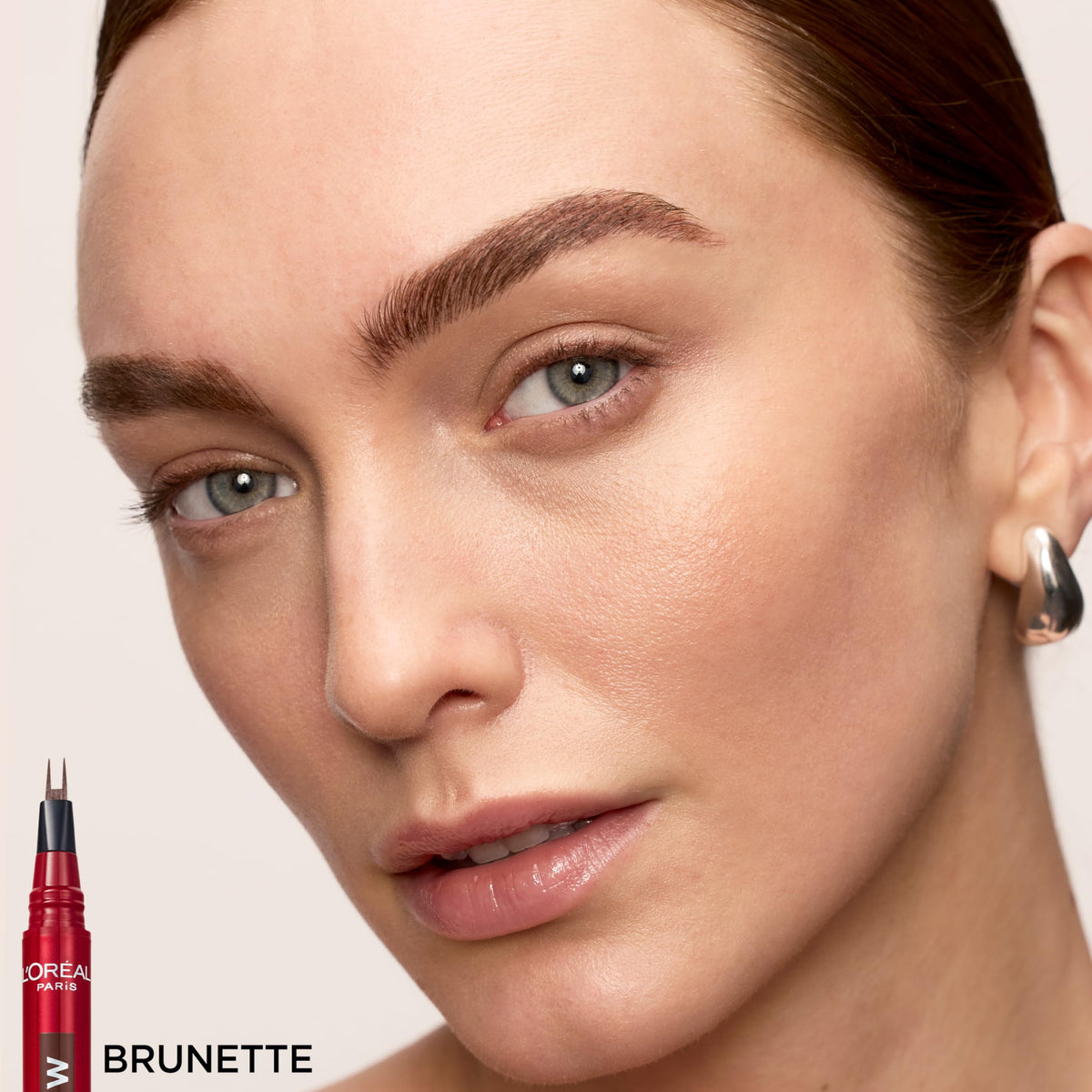 Application scene with L'Oreal Paris at mirror showing fast, on-the-go brow shaping benefit