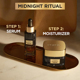 L'Oreal Paris cream on nightstand next to pillow suggesting overnight renewal