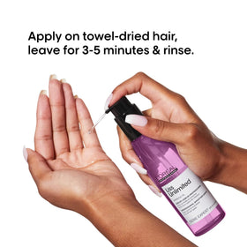 L'Oréal Professionnel applying serum to damp hair for frizz control