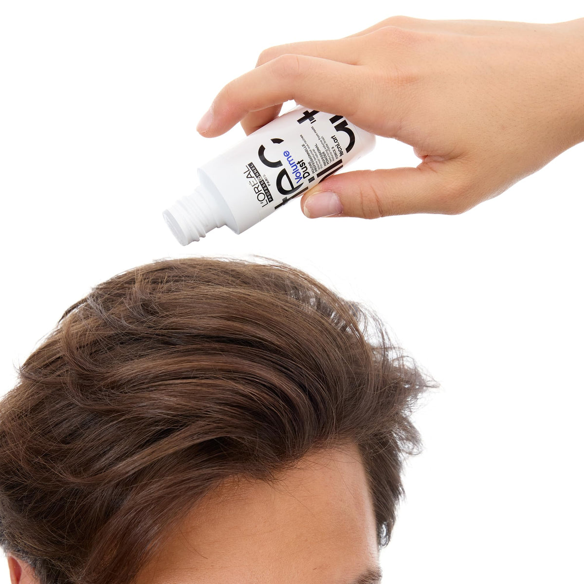 L'Oréal Professionnel Paris beside a hand to show compact size and travel benefit