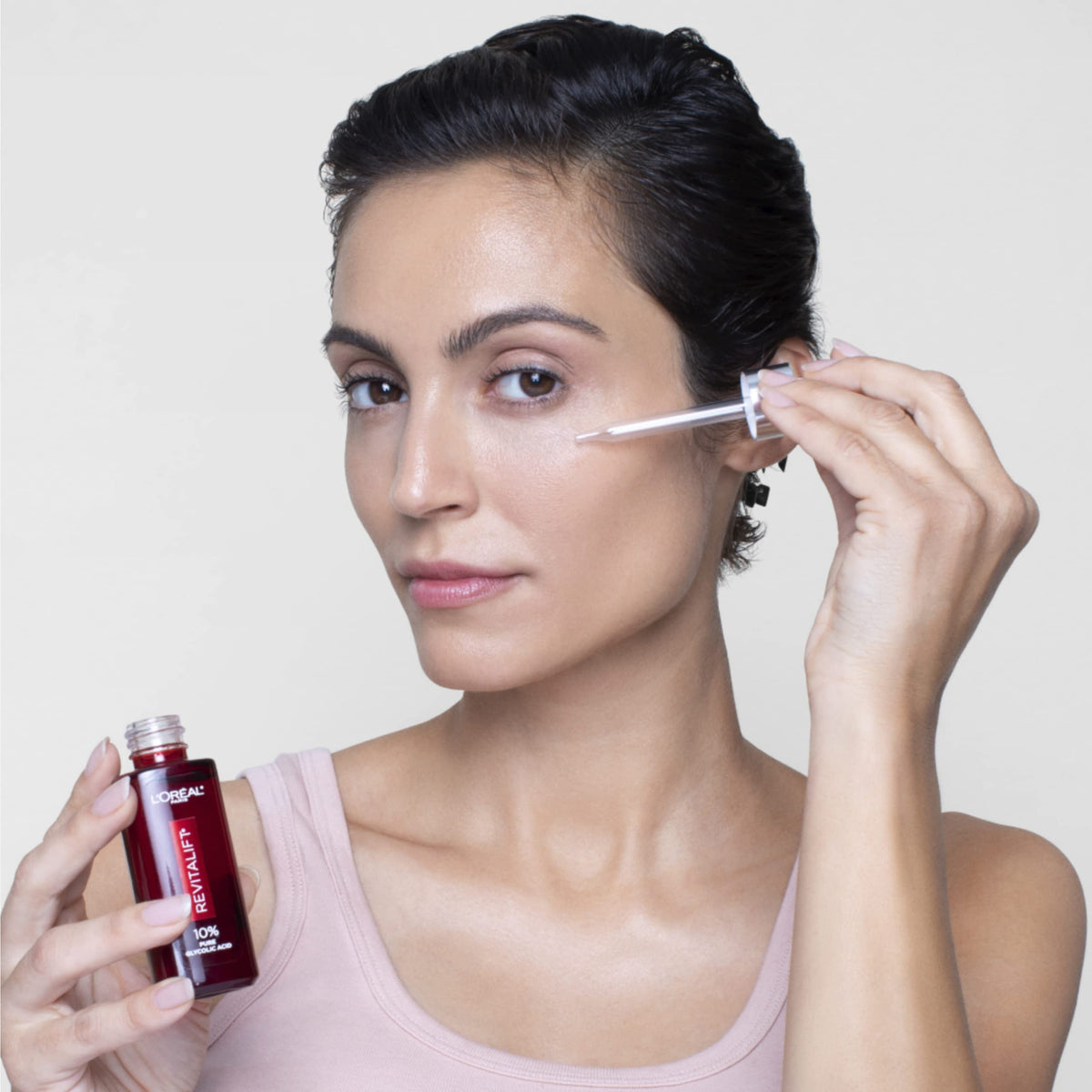 L'Oreal Paris Revitalift application in a nighttime routine demonstrating easy layering benefit
