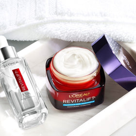L'Oreal Paris Revitalift products alongside a coin for size scale and practical use