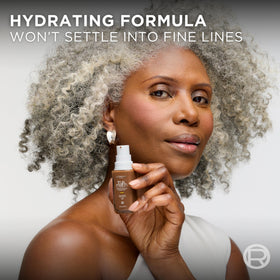 L'Oreal Paris bottle in hand demonstrating compact 1 fl oz scale