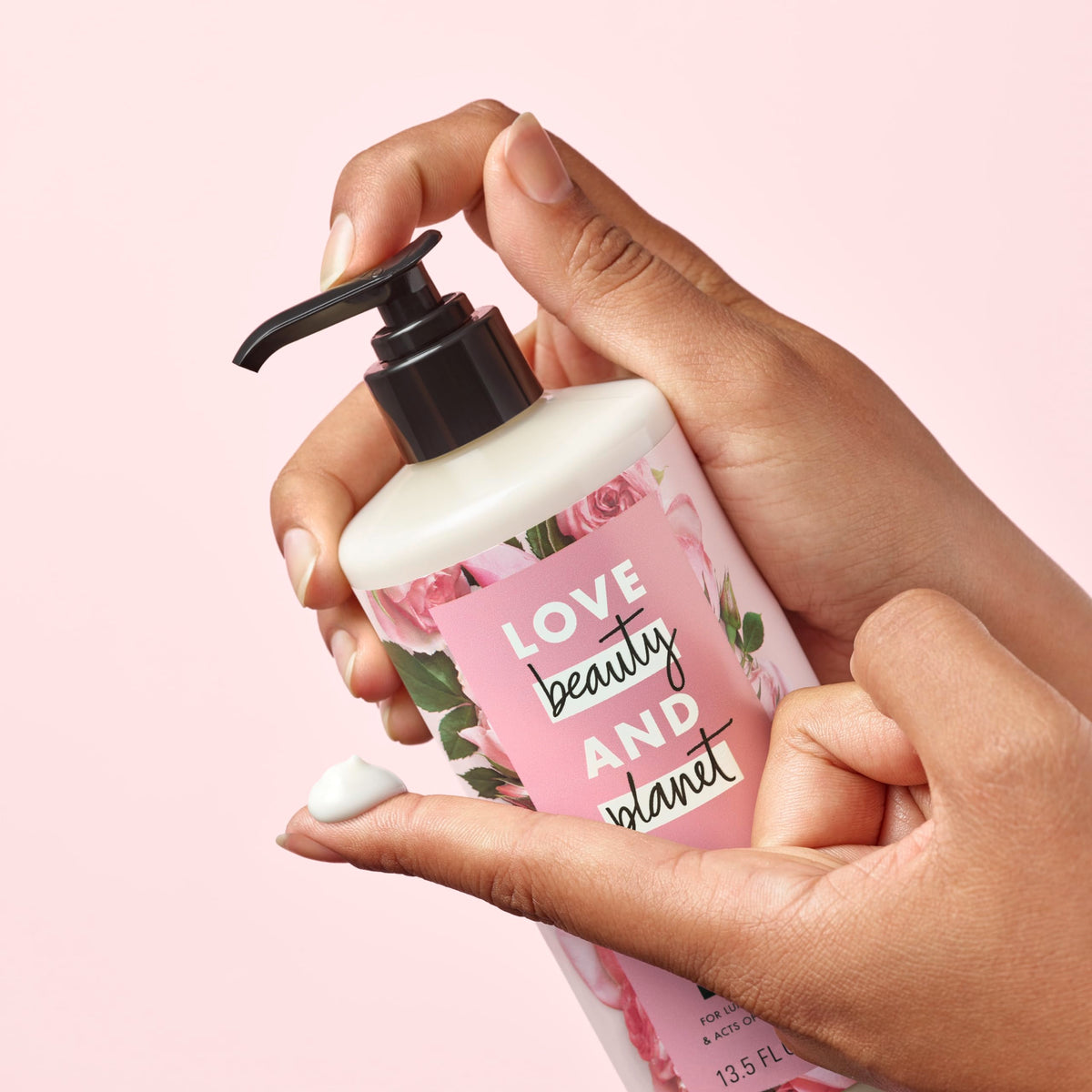 Love Beauty and Planet 13.5 oz bottle held to show actual size