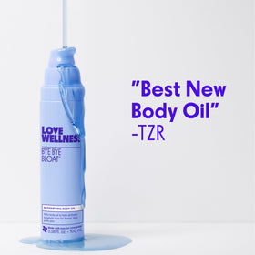 Love Wellness size comparison in hand to show 100 mL scale and portability