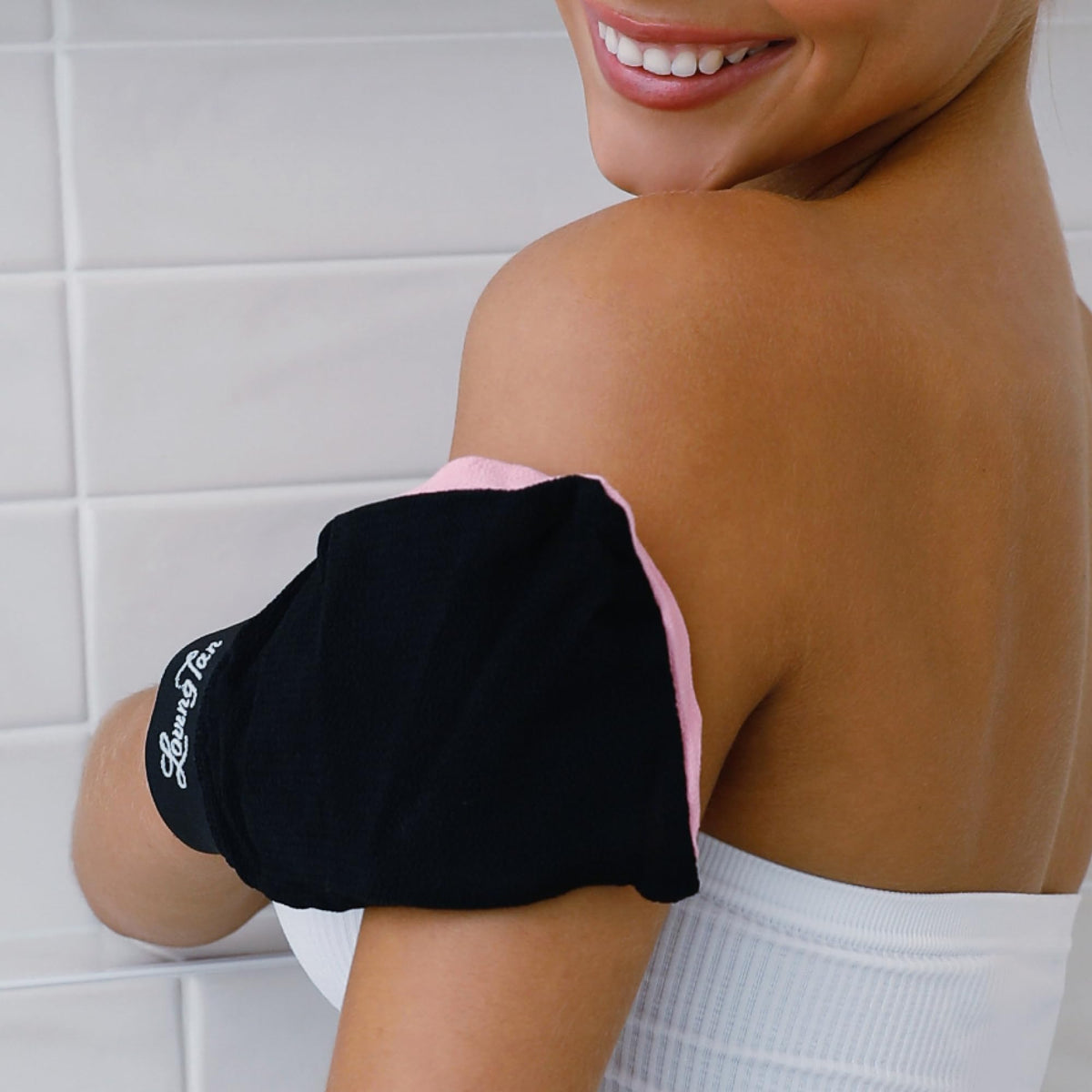 Loving Tan mitt worn on hand demonstrating effortless tan removal benefit