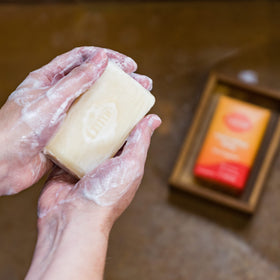 Lume soap bar on dish to show compact size and lasting value