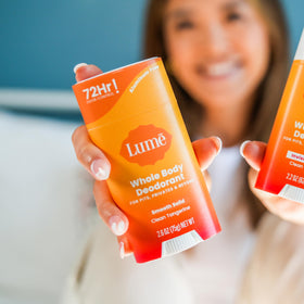Person applying Lume deodorant underarm demonstrating targeted odor control